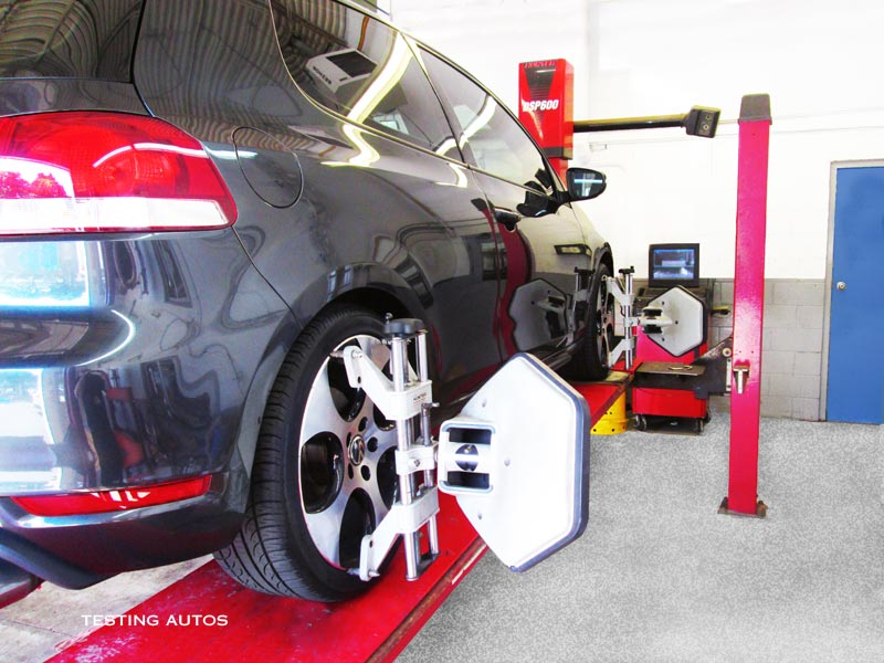 Mechanic inspecting brake rotor and caliper assembly